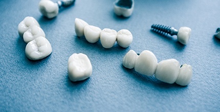 Restorations for dental implants in Millersville resting on table