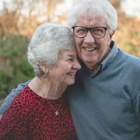 Senior man and woman laughing together outdoors