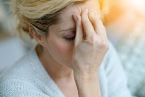 middle-aged woman with a migraine 